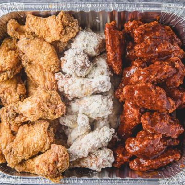 A catering tray of Bonfire Wings with three flavors: plain, lemon pepper, and BBQ.